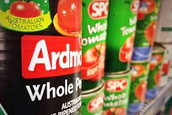 Cans of tomatoes on a shelf.