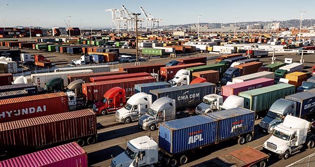 trucks line up to enter a Port of Oakland shipping terminal