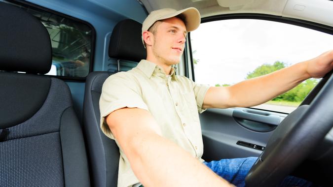a delivery boy driving his van.