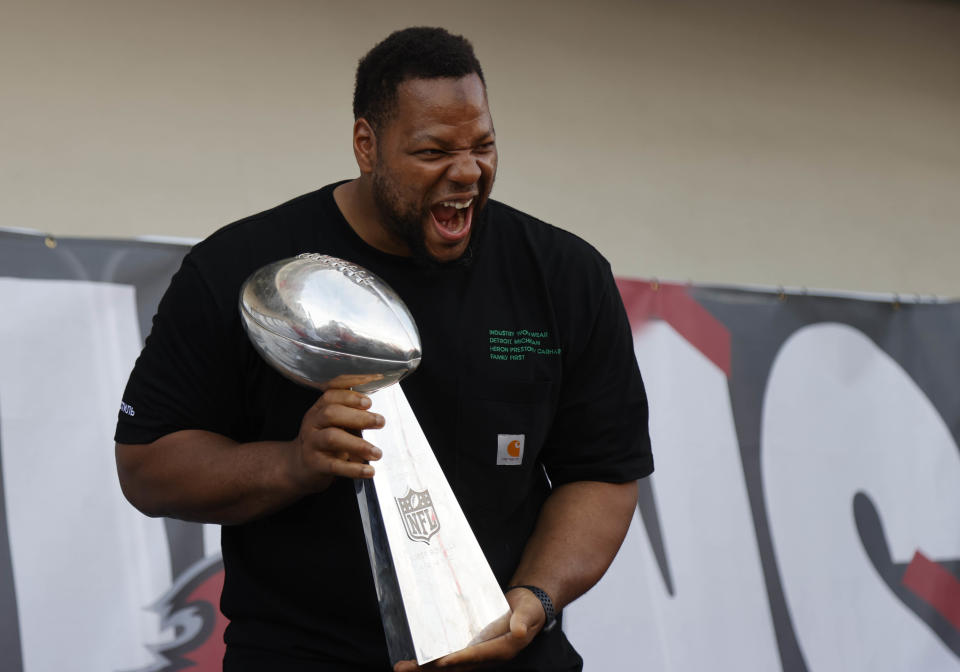 NFL Tampa Bay Buccaneers defensive end Ndamukong Suh holds the Vince Lombardi Trophy during a boat parade to celebrate victory in Super Bowl LV against the Kansas City Chiefs. Mandatory Credit: Kim Klement-USA TODAY Sports
