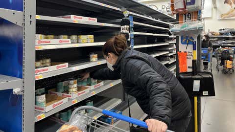 NEW JERSEY, USA - JANUARY 14: A woman buys cat food as nearly empty shelves are seen at a Walmart store on January 14, 2022 in New Jersey, United States amid Omicron variant. The COVID-19 pandemic continues to cause supply chain issues across the country. (Photo by Tayfun Coskun/Anadolu Agency via Getty Images)