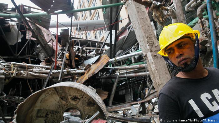 A rescue worker looks for survivors at the site of the Gazipur factory collapse
