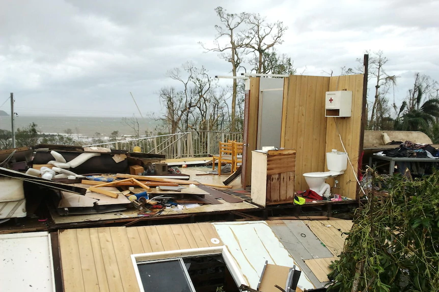 A toilet and two walls are all that stand in the ruins of a home destroyed by a cyclone.