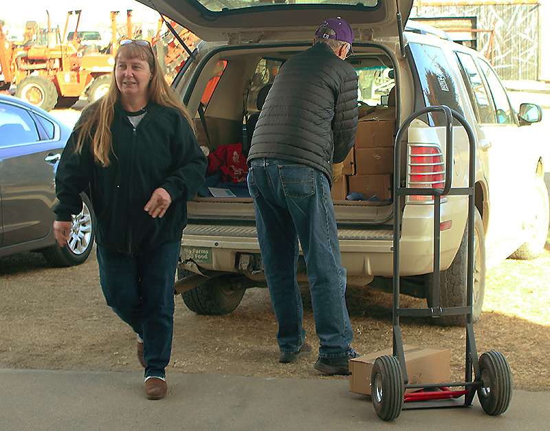 Cases of Zingers being loaded into a vehicle. Photo by Cristina Janney / Hays Post
