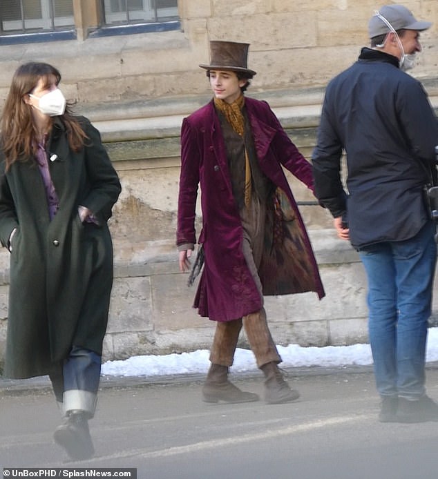 Costume: Timothée layered the coat atop of a brown waistcoat and also wore lace-up boots and pinstripe trousers as part of his costume