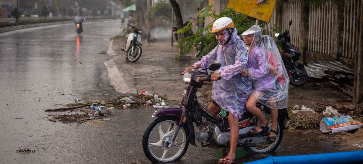 A man carries his children on motorbike passing through the flooded road in Da Nang City, Vietnam on October 30, 2020, in the aftermath of Typhoon Molave. A man carries his children on motorbike passing through the flooded road in Da Nang City, Vietnam on October 30, 2020, in the aftermath of Typhoon Molave.