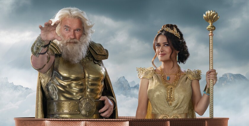 A man in a metallic chest plate and cuffs with white hair and beard and a woman in a gold gown holding a staff.