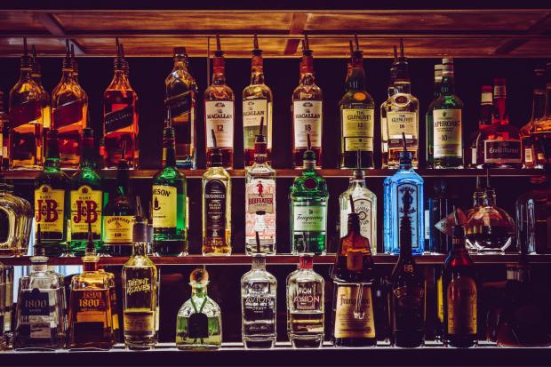 Oxford Mail: Shelves of alcoholic spirits to make cocktails. Credit: Canva