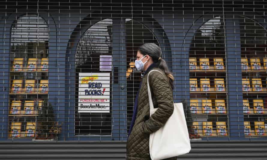 A woman walks by Books Are Magic bookstore in the Brooklyn borough of New York City.