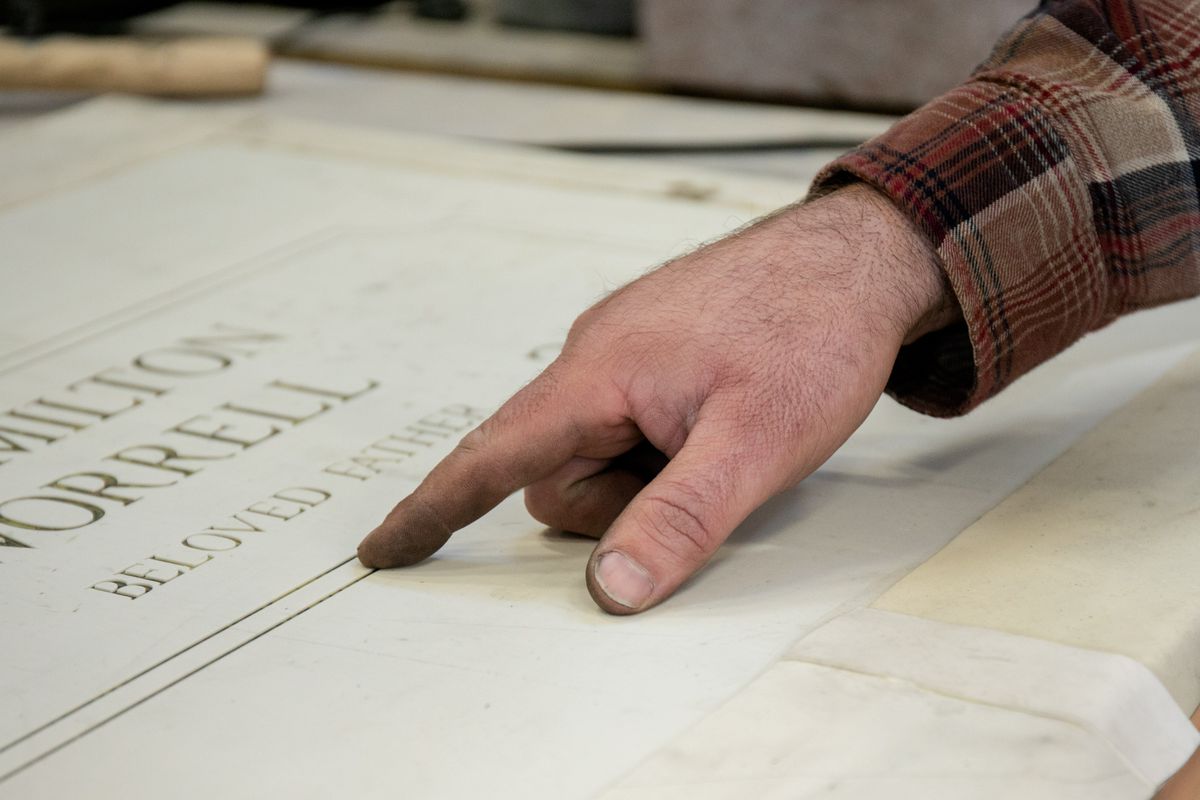 ABC Monuments owner George Pantelic points to a rubbery material, which is in short supply, that he uses to stencil letters and designs on headstones at ABC Monuments in the Lawndale neighborhood, Friday afternoon, Feb. 18, 2022. ABC Monuments has faced a shortage of materials because of supply chain issues and backlogged orders. They import materials from India and China, according to Pantelic.