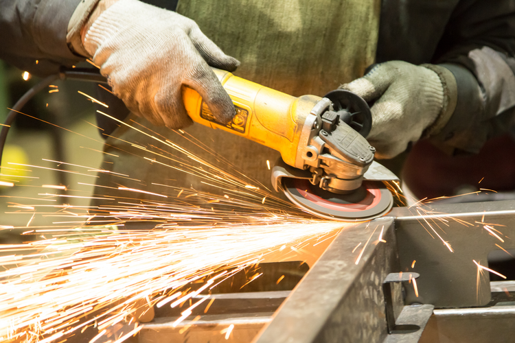 person working on welding machine