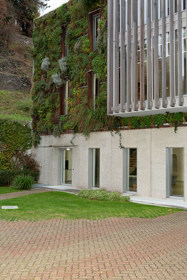 Herno factory facade featuring a green wall by Mancuso & Turba Associati