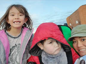Emiko, 6, Ryan, 8, and mother Fuyo Watanabe (R) are shown in a recent family photo. Her son is very high needs, with severe allergies. Their doctor says he needs a HEPA filter in the classroom.