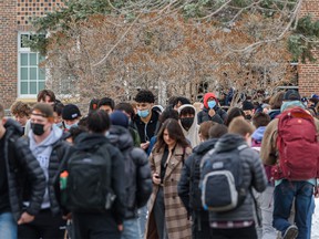 Students at Western Canada High School exit the school for their lunch break on their first day of being back in classes in the new year on Monday, January 10, 2022.