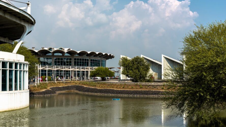 Three buildings that hug a body of water