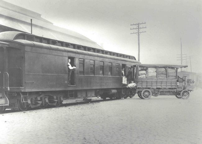 Employees transfer bags of mail from a truck into RPO #1012 of the Lehigh Valley Railroad, which connected New York City and Buffalo by way of northeastern Pennsylvania and Geneva, New York. All-steel RPO railcars like the one pictured were used as early as 1905 on some lines and grew more numerous following the Steel Car Act of 1912. The USPOD first issued safety specifications to railroad companies for car construction in 1891, following a deadly train wreck at Kipton, Ohio, that claimed the lives of six clerks. (Photo: USPS Collection)