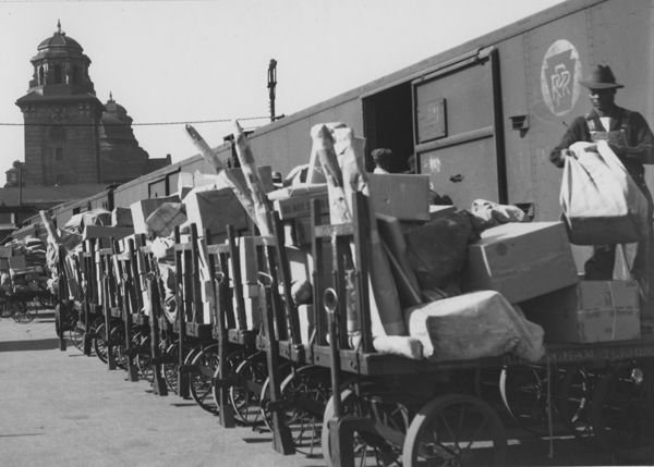 Bags and parcels wait to be loaded into storage mail cars at the Birmingham, Alabama, Terminal. The improvement of interstate highways and an increase in automobile ownership, along with the growth of the commercial airline industry, led to a decrease in passenger train service in the 1950s and 1960s. With fewer trains running, mail transportation gradually shifted from railroad to highway and skyway. (Photo: USPS Collection)