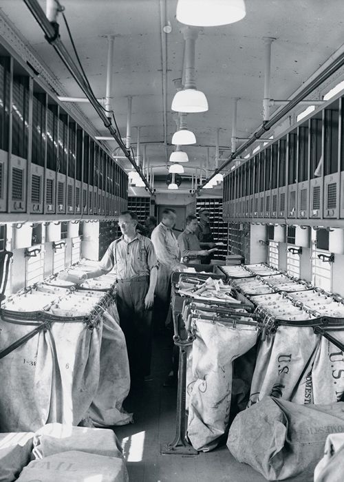 Clerks sort mail inside an RPO. Railway mail clerks “dressed” RPOs before each run by hanging sacks on the iron racks and then labeling them with the destination post offices along a particular run. Letter-sorting machines, which began appearing in postal facilities in the 1960s, gradually reduced the need for manual sorting of mail, including en route in RPOs. The last RPO route, between New York City and Washington, D.C., was discontinued in 1977. (Photo: USPS Collection)