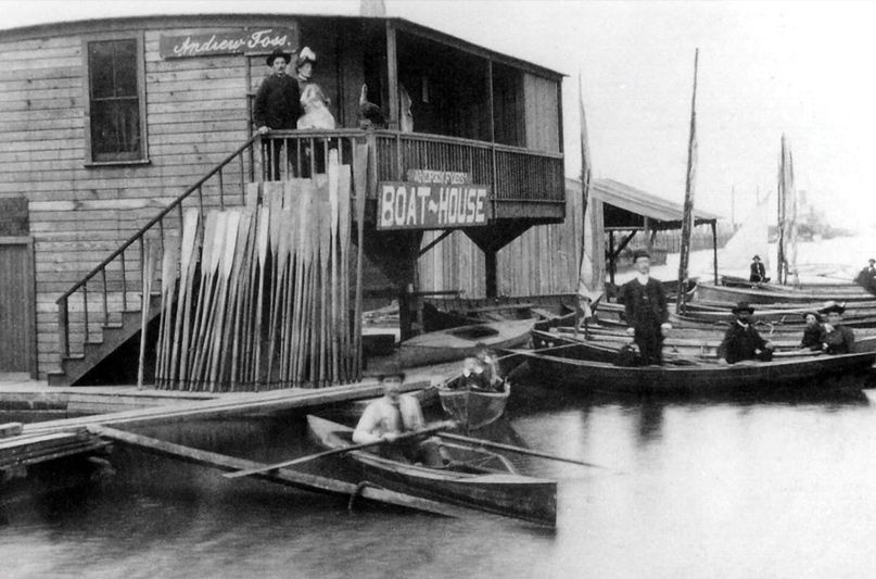 The Foss family float home became the base of operations for a rowboat and launch rental business; about nine boats are visible in this 1890 photo of the boathouse. They also established a small dry goods store in the boathouse. (Photo: Foss Waterway Seaport/nwyachting.com)