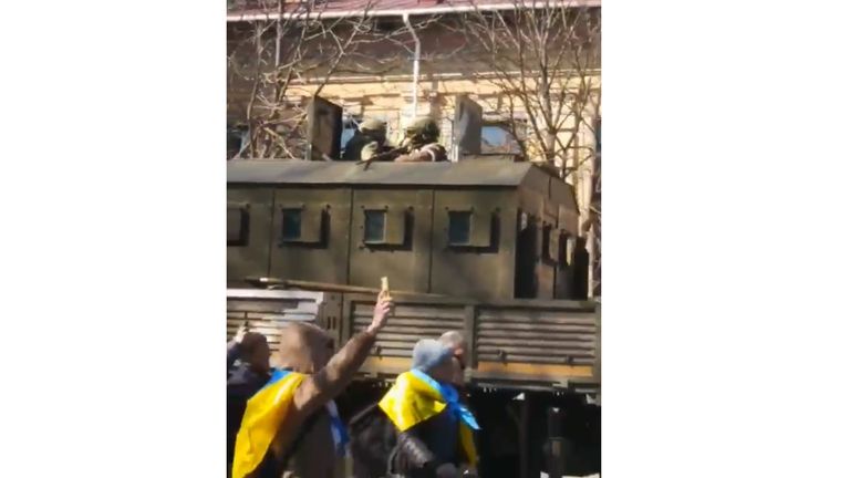 Russian soldiers aimed their weapons at a Ukrainian protest filing past