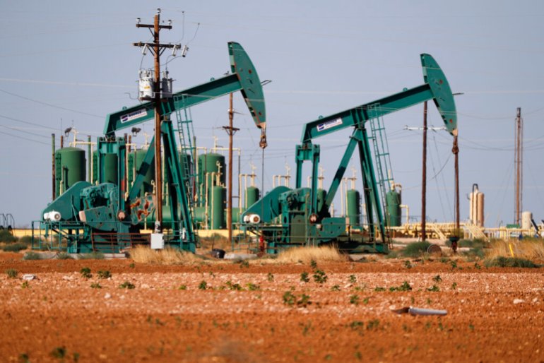 a view of a pump jack operateing in an oil field in Midland, Texas.
