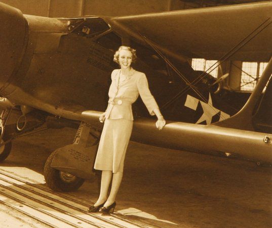 Olive Ann Beech leans against the lower wing of a biplane built for the U.S. Army Air Corps. (Photo: kingairnation.com)