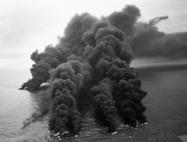 The huge pall of smoke from the Torrey Canyon as it was bombed to reduce the oil spill