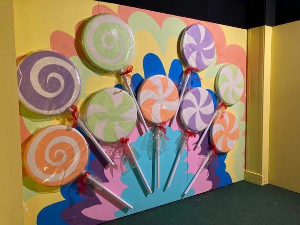 There are candy-themed backdrops for photo opportunities at The Chocolate Factory.