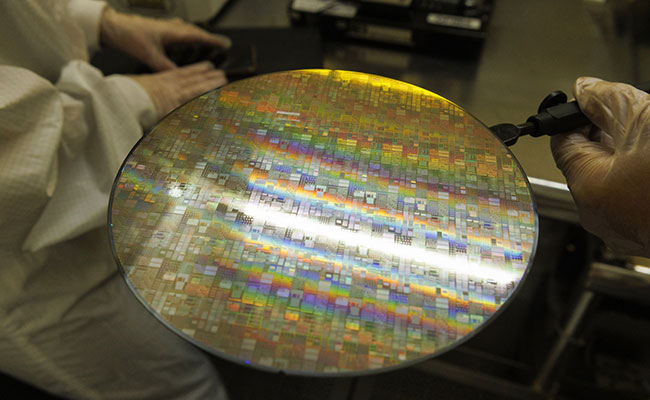 Technicians inspecting a semiconductor