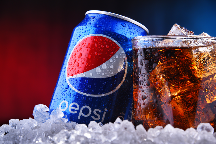 Pepsi can alongside glass of pepsi