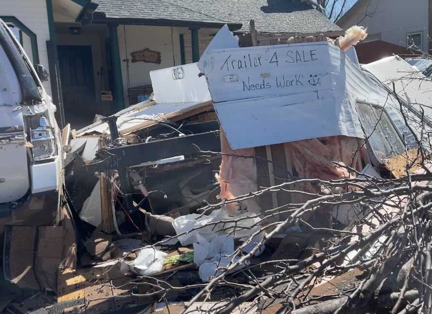 'Trailer 4 SALE: Needs Work' sign on trailer that was destroyed in Monday night's storms in Round Rock. (KXAN Photo/Maggie Glynn)