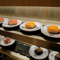 A conveyor belt of sushi at a restaurant in Tokyo. As of Friday, the wholesale price of Norwegian salmon was at ¥2,000-¥2,200 per kilogram at the capital's Toyosu market, some 30% higher than in February. | REUTERS