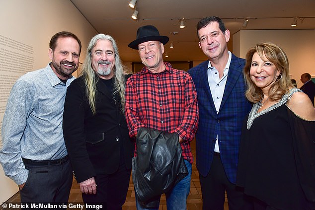 Willis' assistant Stephen J. Eads (pictured to Willis' direct left), would make up to $200,000 and receive a producer credit on films for shepherding Willis and 'keeping an eye on him'