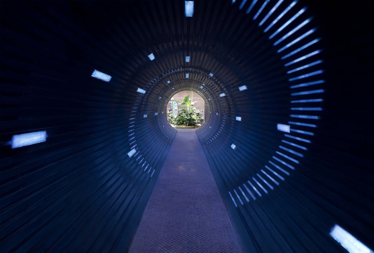 Looking through the pipe from the exhibition hall to acacia island, the lighting installation - designed by Lumia Lab - "return" , with spiral lighting twirls to one direction and beam shaped light points to another, creating an illusion of moving space and time. Image © Zhi Xia
