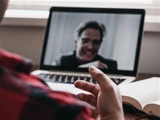 having  a  video chat, person on camera  laughing