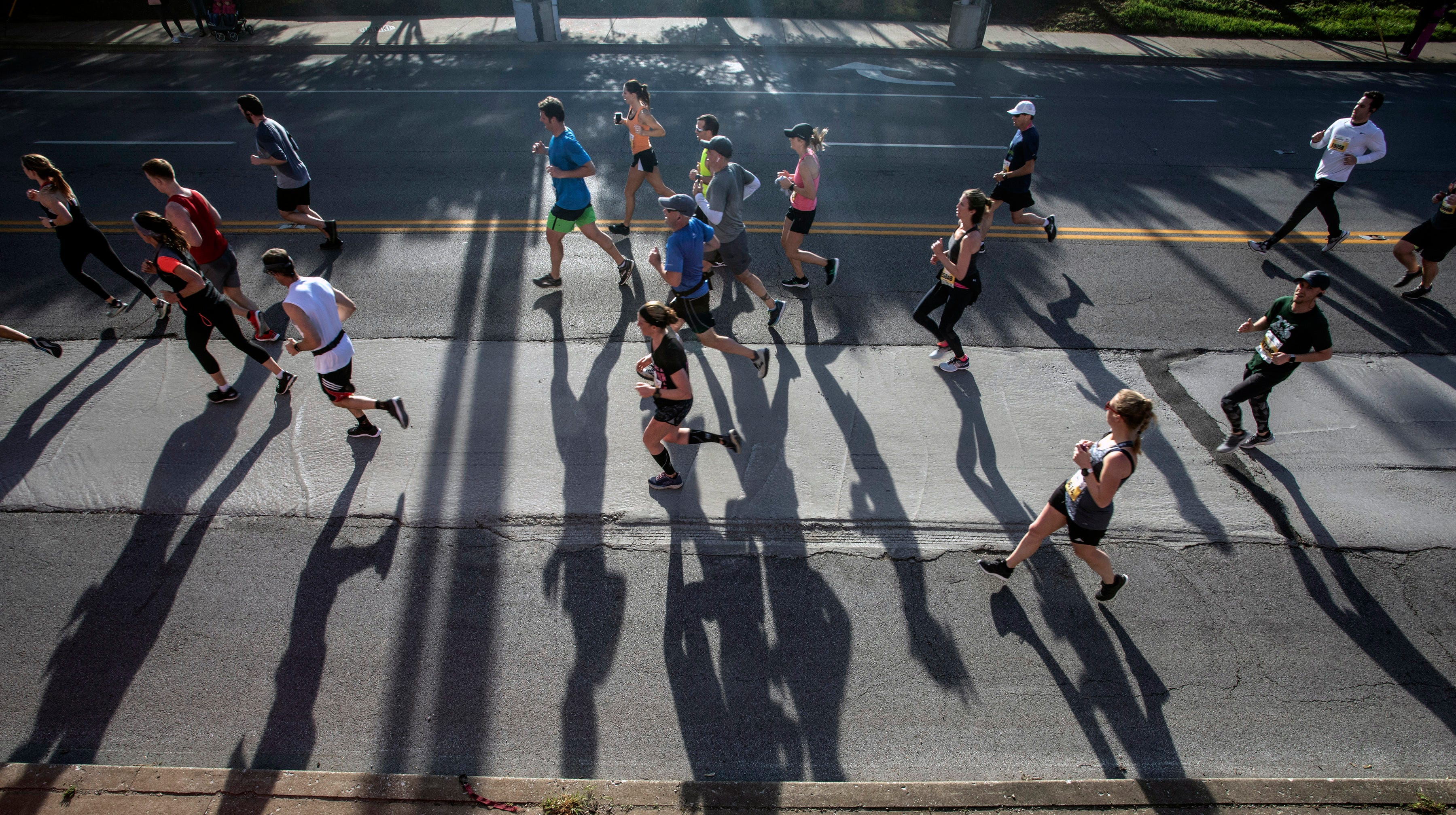 KDF miniMarathon runners cast long shadows from the morning sun on Saturday. 4/26/19