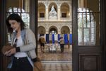 A woman leaves the polling station after voting in the second round of the French presidential election in Lyon, central France, Sunday, April 24, 2022. France began voting in a presidential runoff election with repercussions for Europe's future, with centrist incumbent Emmanuel Macron the front-runner but fighting a tough challenge from far-right rival Marine Le Pen.