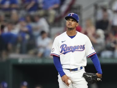 Texas Rangers relief pitcher Albert Abreu reacts after a single by Los Angeles Angels center...