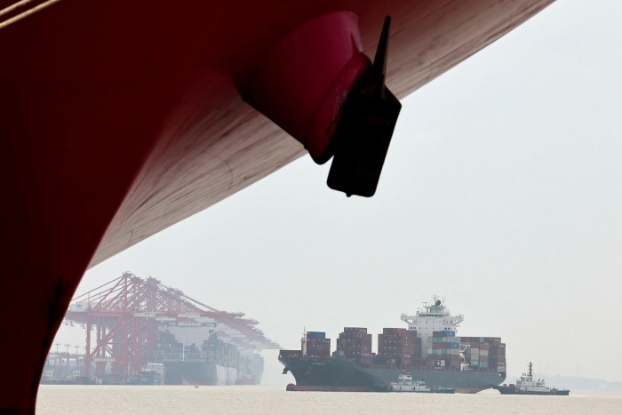A container ship sails towards the dock of Shanghai’s Yangshan port.