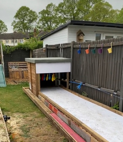 The bowling lane has a ramp for the ball to return back to the start