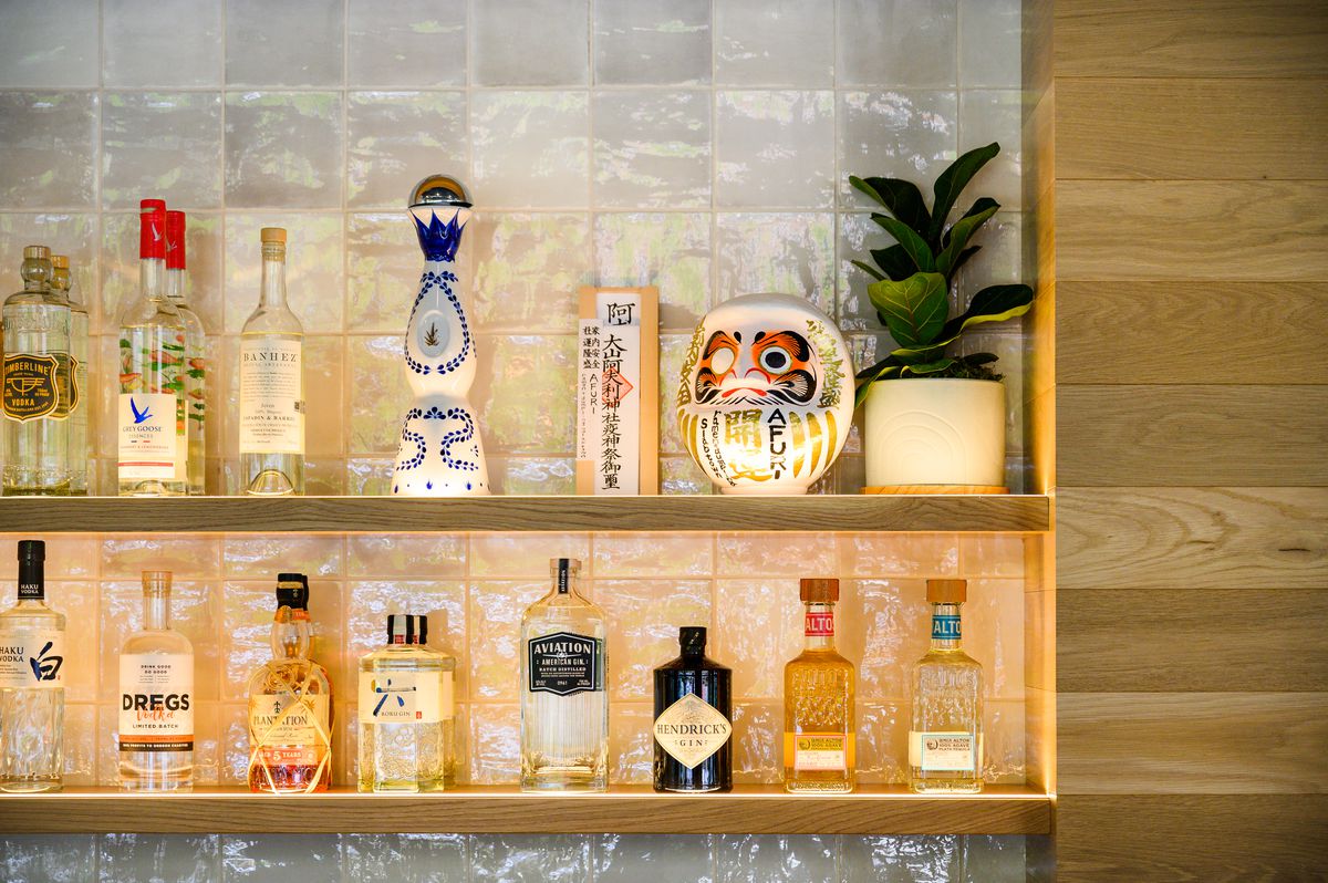 Bottles of whiskey, gin, and vodka — both local and international — sit on the bar at Afuri Slabtown in Portland, Oregon.