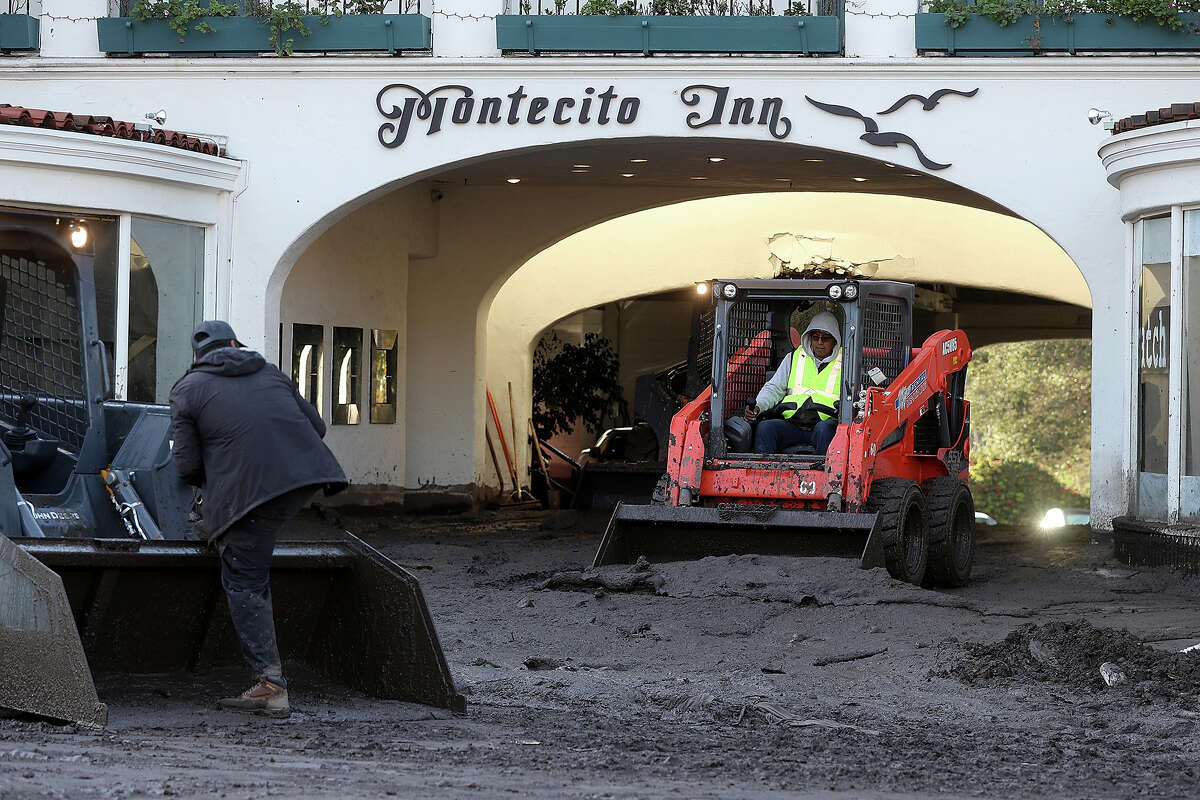 Workers clear mud from the parking garage at the Montecito Inn following a mudslide on Jan. 12, 2018, in Montecito. While the hotel survived, many historic structures were buried and 23 lives were lost.