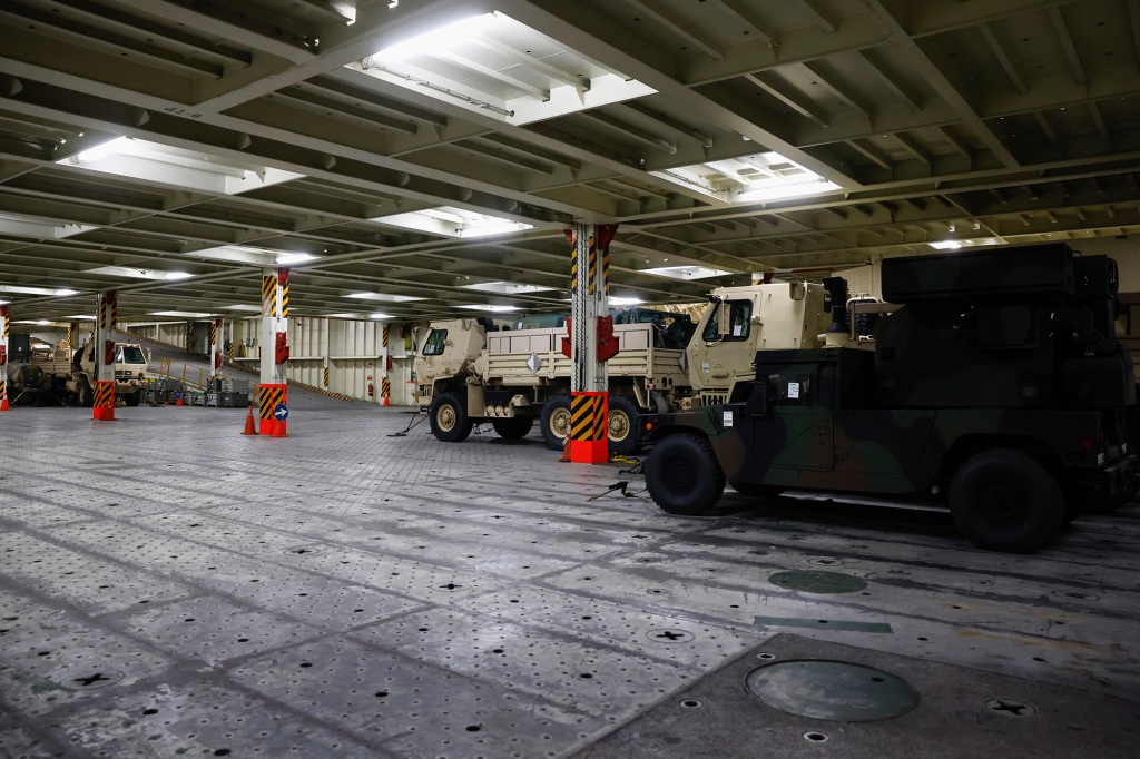 Military vehicles are photographed inside a cargo ship set to deliver military supplies to Ukraine amid Russia's invasion, during a visit by Carol A. Petsonk, Principal Deputy Assistant Secretary for Aviation and International Affairs at the U.S. Department of Transportation, in Antwerp, Belgium, Friday, May 20, 2022.