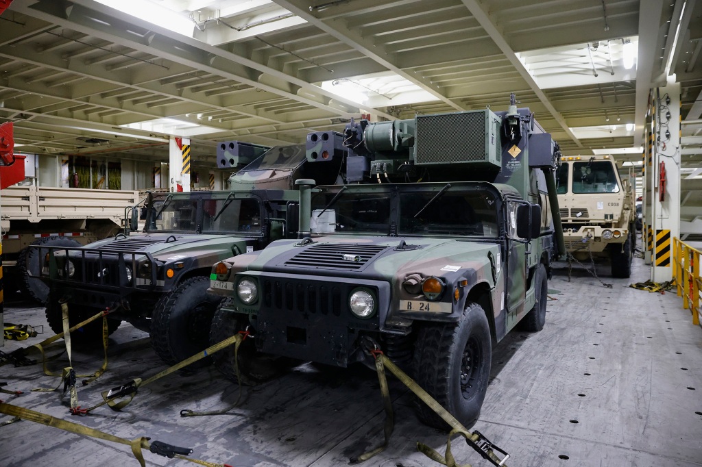 Military vehicles are photographed inside a cargo ship set to deliver military supplies to Ukraine amid Russia's invasion, during a visit by Carol A. Petsonk, Principal Deputy Assistant Secretary for Aviation and International Affairs at the U.S. Department of Transportation, in Antwerp, Belgium, Friday, May 20, 2022.