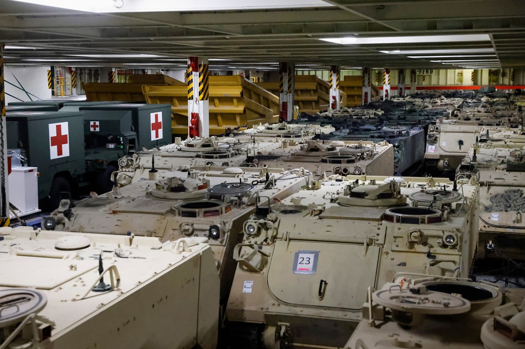 Military vehicles are photographed inside a cargo ship set to deliver military supplies to Ukraine amid Russia's invasion, during a visit by Carol A. Petsonk, Principal Deputy Assistant Secretary for Aviation and International Affairs at the U.S. Department of Transportation, in Antwerp, Belgium, Friday, May 20, 2022.