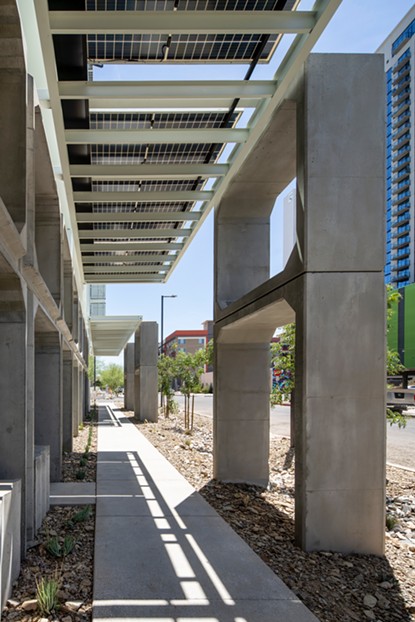 A unique solar overhang spans the length of the six-story building and cloaks the sidewalk below in shade. - WILLIAM LEGOULLON