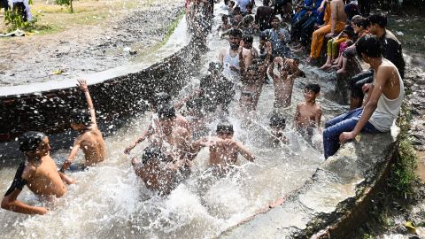 People cool themselves in a canal in Lahore, Pakistan, on April 29.