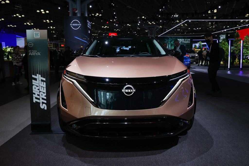 The front view of a pink electric 2023 Nissan Ariya at the 2022 New York Auto Show
