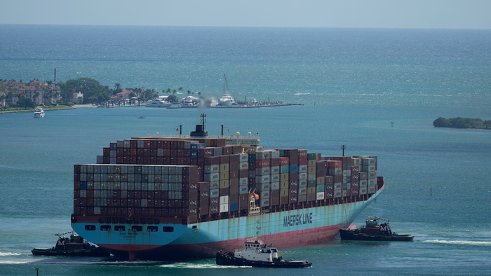 Three tugboats work together to rotate the Axel Maersk container ship as it arrives into port, on Oct. 21, 2021, in Miami.