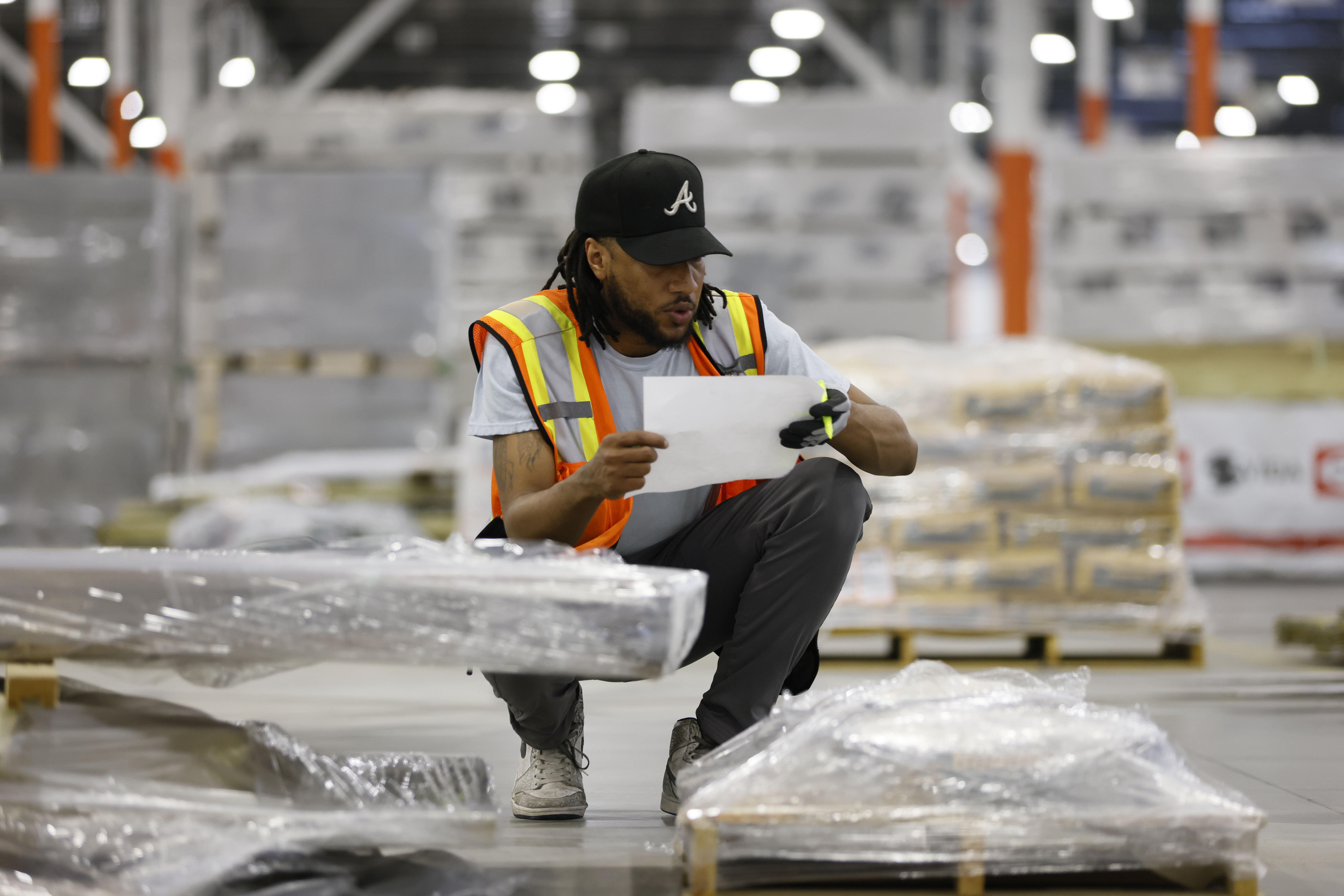 General warehouse associate Chad Witcher checks the order of the material he is taking to a flatbed truck for distribution. The massive new Home Depot warehouse in Stonecrest has more than two hundred employees distributed in three-shifts that work twenty hours a day. Monday, May 23, 2022. Miguel Martinez / miguel.martinezjimenez@ajc.com